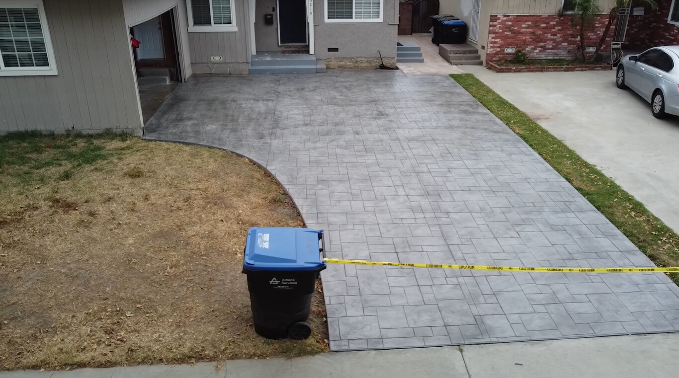 Stamped and decorative concrete driveway with brick pattern